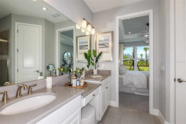 bathroom with tile patterned floors, vanity, and ornamental molding