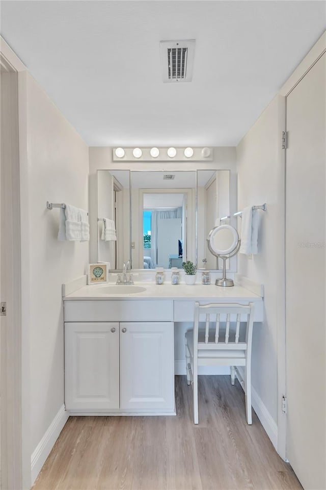 bathroom featuring hardwood / wood-style flooring and vanity