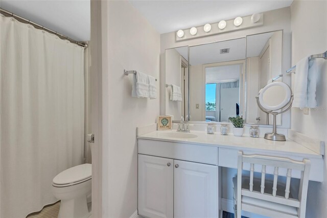 bathroom featuring vanity and toilet