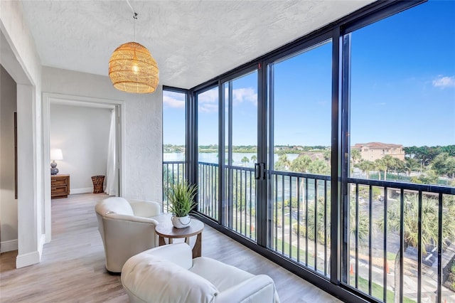 sunroom / solarium with a water view