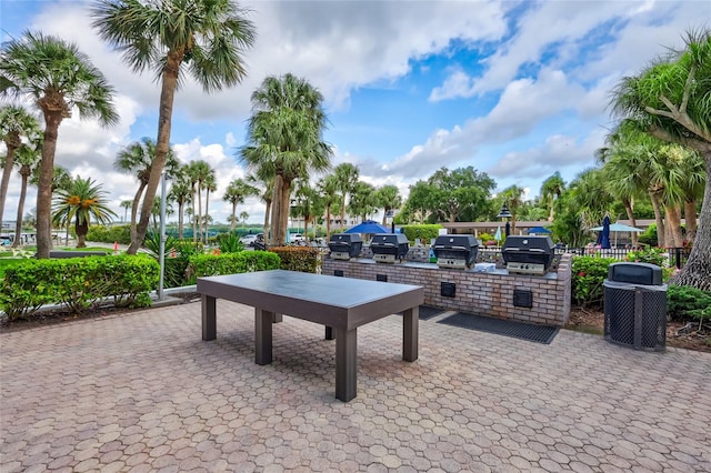 surrounding community featuring a patio and area for grilling