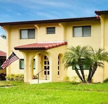 rear view of house featuring a lawn