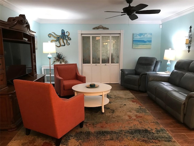 living room with ceiling fan, dark hardwood / wood-style flooring, and ornamental molding