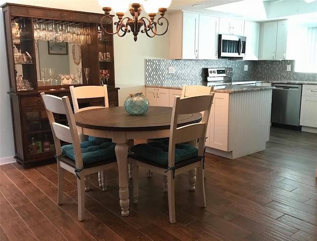 dining area with dark hardwood / wood-style flooring