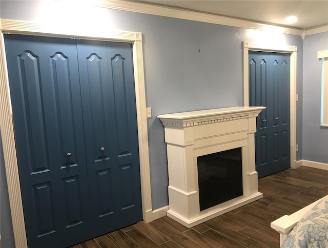 living room with dark hardwood / wood-style flooring and ornamental molding