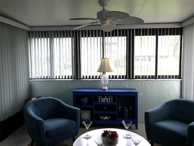 sitting room with tile patterned flooring and ceiling fan