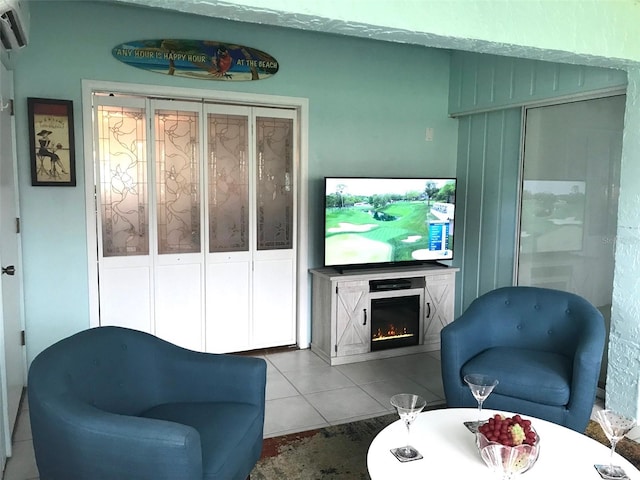 tiled living room featuring a wall mounted air conditioner