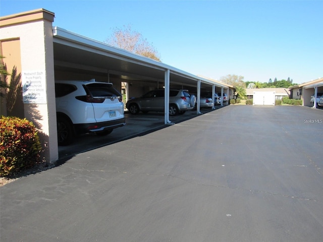 view of vehicle parking with a carport