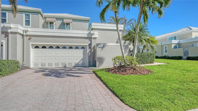 view of front of property with a garage and a front lawn