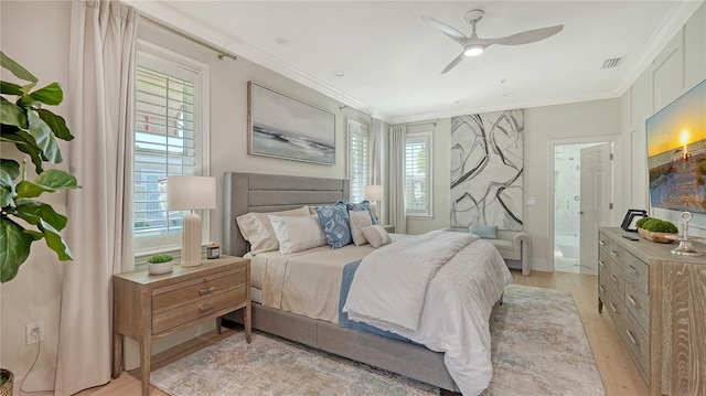 bedroom featuring ceiling fan, light hardwood / wood-style floors, connected bathroom, and multiple windows