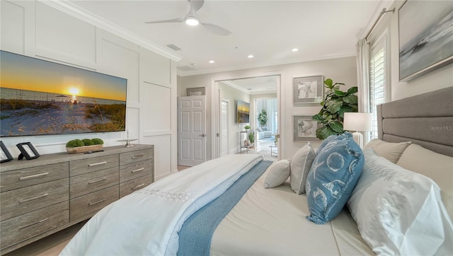 bedroom featuring multiple windows, crown molding, and ceiling fan