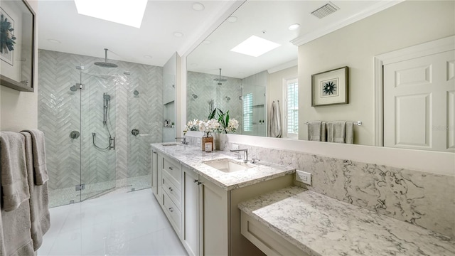 bathroom featuring a skylight, vanity, and walk in shower