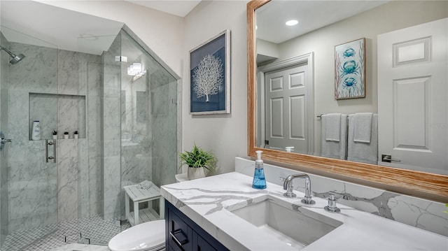 bathroom featuring vanity, toilet, and a shower with shower door