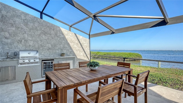 view of patio / terrace featuring sink, a grill, wine cooler, area for grilling, and a water view