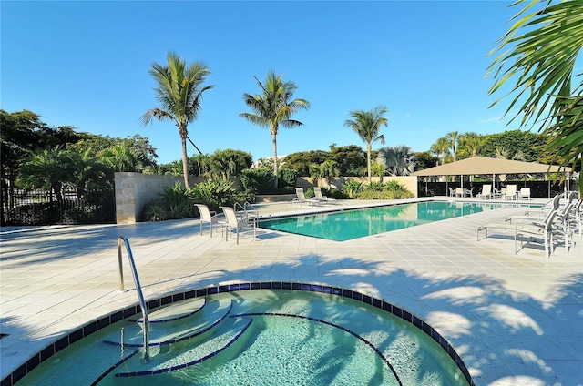 view of swimming pool with a patio area and a community hot tub