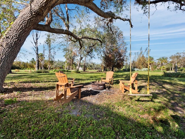 view of yard featuring an outdoor fire pit