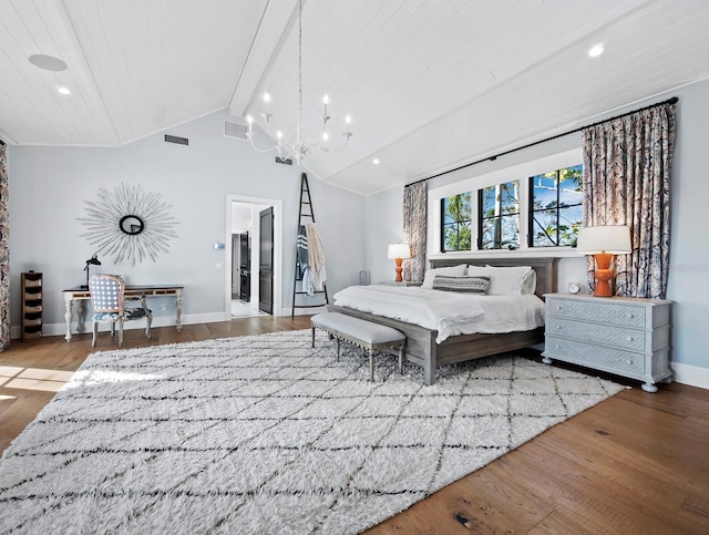 bedroom with ensuite bath, a chandelier, hardwood / wood-style floors, and lofted ceiling with beams