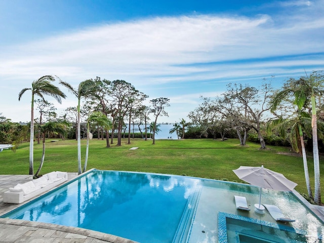 view of swimming pool featuring a lawn