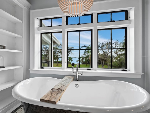 bathroom with a washtub and crown molding