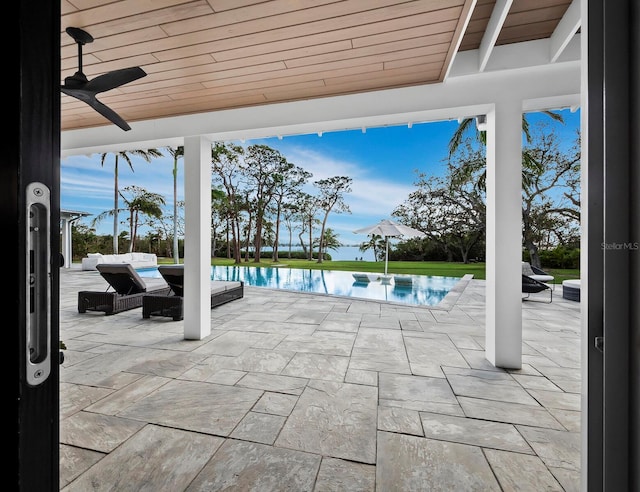 view of patio / terrace featuring ceiling fan and a water view