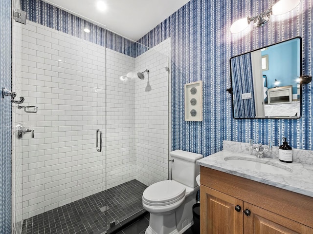 bathroom with vanity, toilet, and a shower with shower door