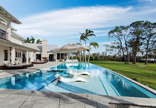 view of pool featuring a lawn, an outdoor hangout area, and a patio