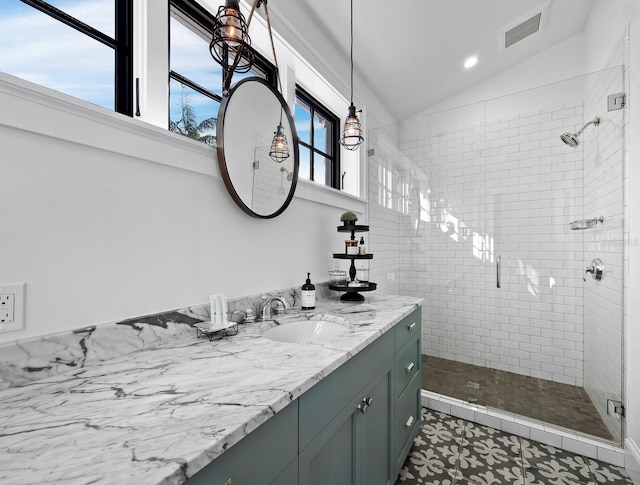 bathroom with vanity, a healthy amount of sunlight, lofted ceiling, and a shower with door