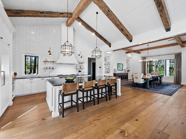 kitchen with white cabinetry, a wealth of natural light, and hanging light fixtures