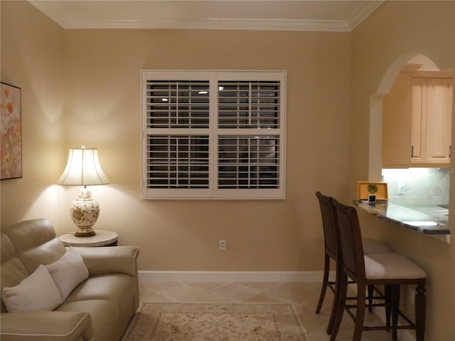 home office with light tile patterned floors and crown molding