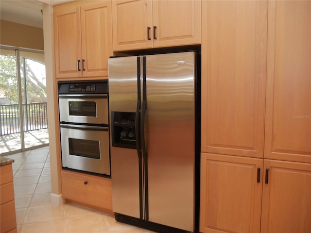 kitchen with stainless steel appliances, light tile patterned flooring, and ornamental molding