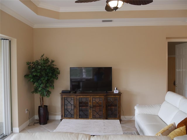 living room with light tile patterned flooring, crown molding, and ceiling fan