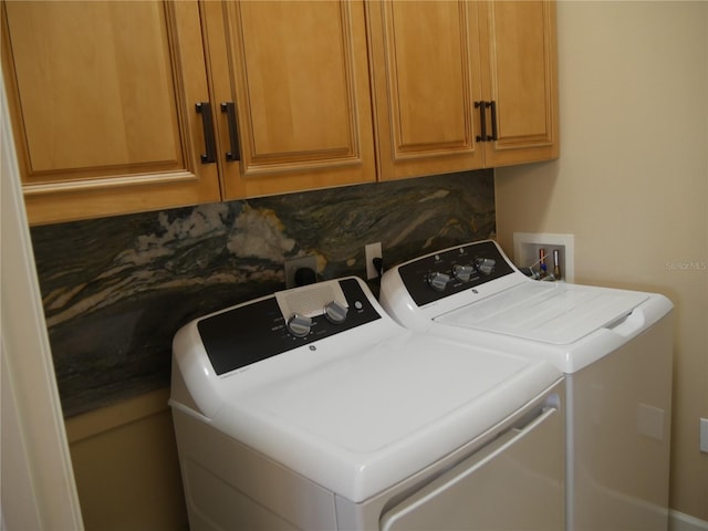 laundry area featuring cabinets and separate washer and dryer