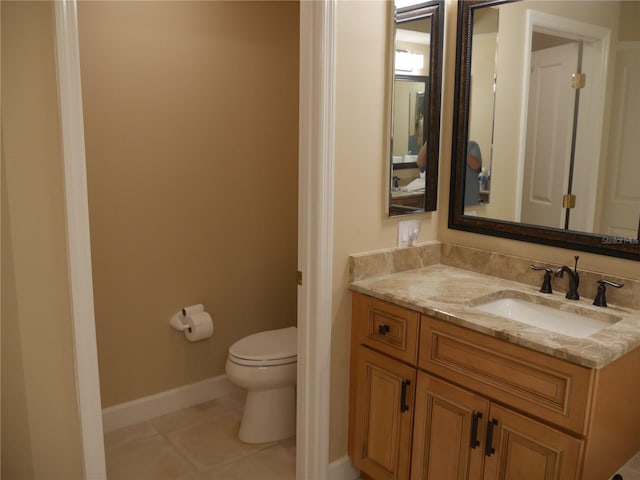 bathroom featuring vanity, tile patterned floors, and toilet