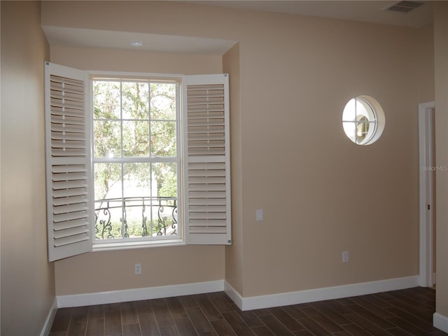 spare room with dark hardwood / wood-style flooring