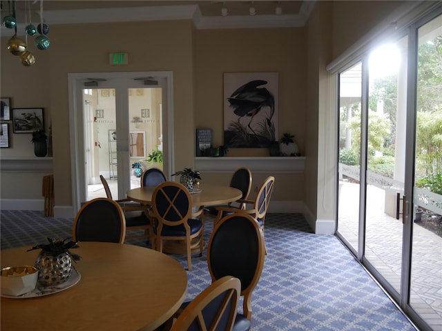 dining room with crown molding, french doors, and carpet floors