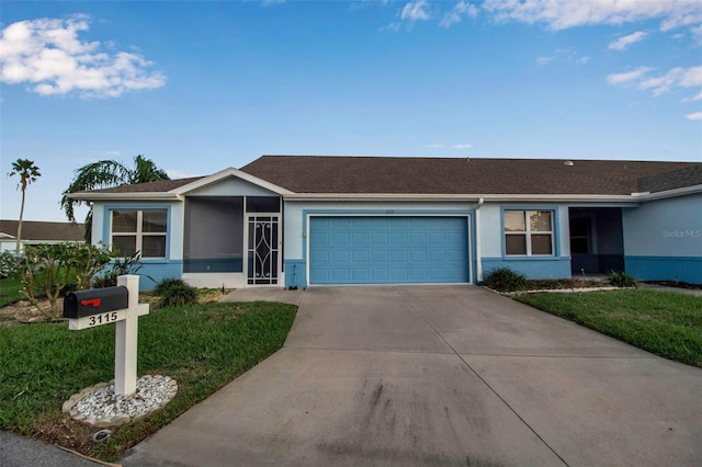 single story home featuring a garage and a front lawn