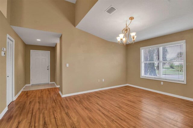 3115 Live Oak Ln Unit 30, Palmetto, FL 34221 - empty room featuring a chandelier, light wood finished floors, and baseboards