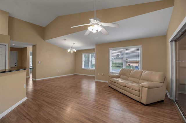 3115 Live Oak Ln Unit 30, Palmetto, FL 34221 - living area featuring a chandelier, light wood-style floors, ceiling fan, vaulted ceiling, and baseboards