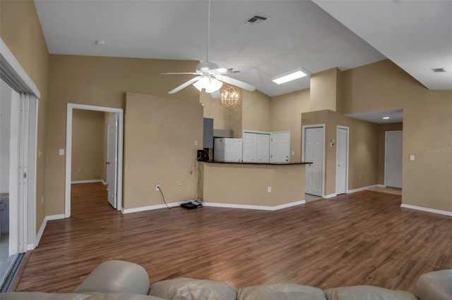 unfurnished living room with hardwood / wood-style flooring, ceiling fan, and high vaulted ceiling