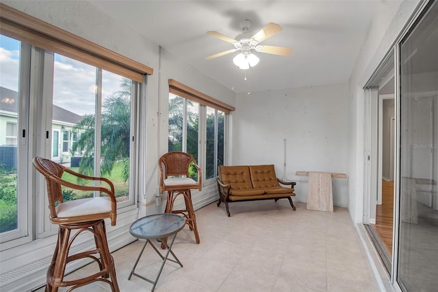 sunroom with plenty of natural light and ceiling fan