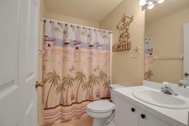 bathroom featuring toilet, vanity, and tile patterned floors