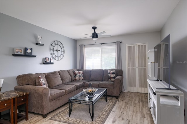 living room with ceiling fan and light wood-type flooring