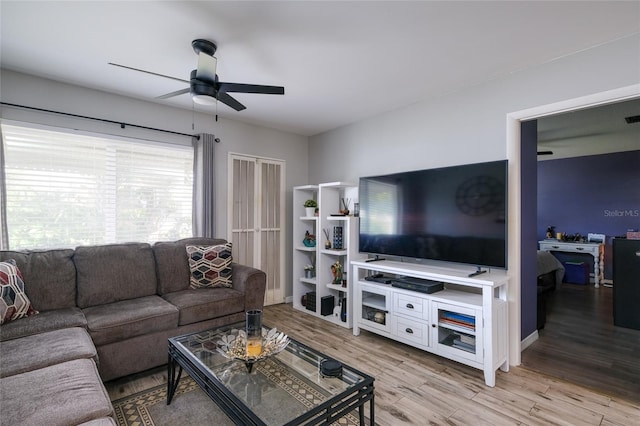living room featuring ceiling fan and light wood-type flooring