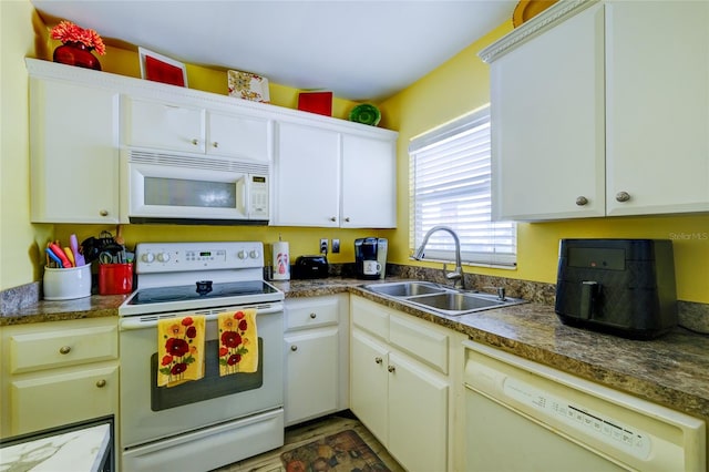 kitchen featuring white cabinetry, sink, and white appliances