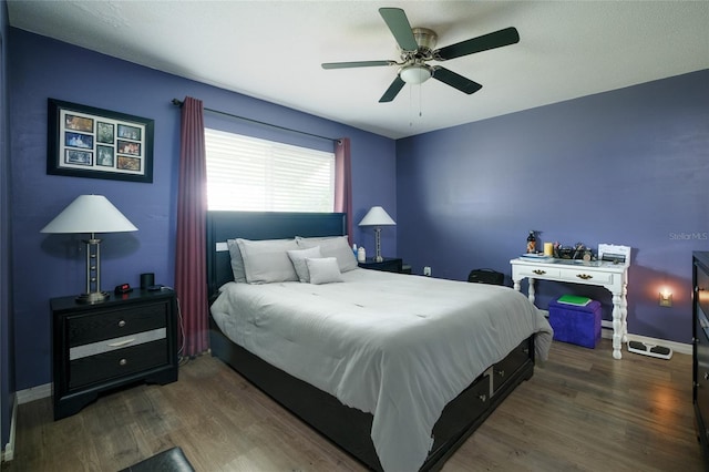 bedroom featuring dark wood-type flooring and ceiling fan
