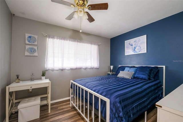 bedroom with dark hardwood / wood-style flooring and ceiling fan