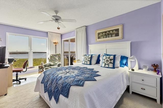 bedroom with a textured ceiling, ceiling fan, and carpet floors