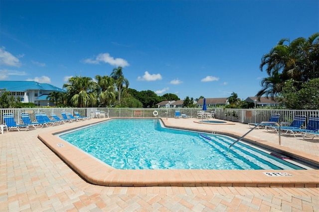 view of pool with a patio area and a hot tub