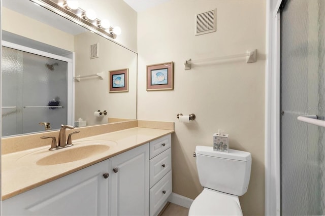 bathroom featuring walk in shower, vanity, and toilet