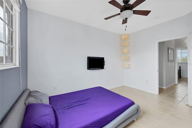 bedroom featuring light tile patterned flooring and ceiling fan